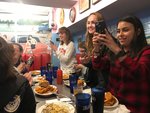 JMArts students takes photos while enjoying performances during lunch at Ellen’s Stardust Diner near Times Square.